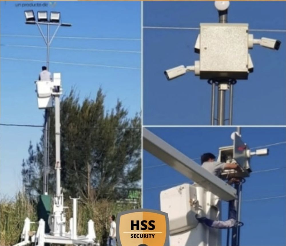 Técnico de HSS instalando un gabinete con cámaras en una columna desde un hidroelevador