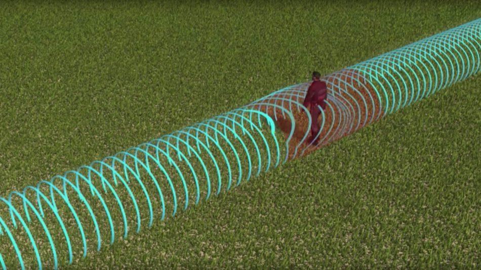 Campo de detección invisible a lo largo de un cable sensor enterrado, alterado por el paso de una persona
